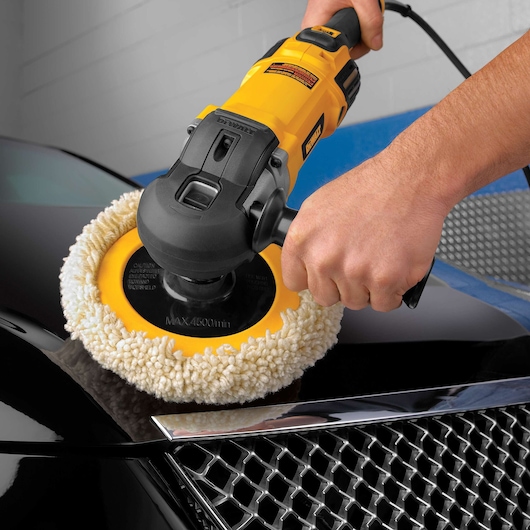 DEWALT polisher being used on a car hood to shine the surface.