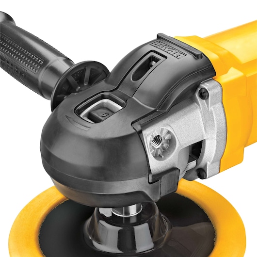 Close-up view of a DEWALT electric polisher with a yellow and black body, a side handle, and a large polishing pad attached to the head.