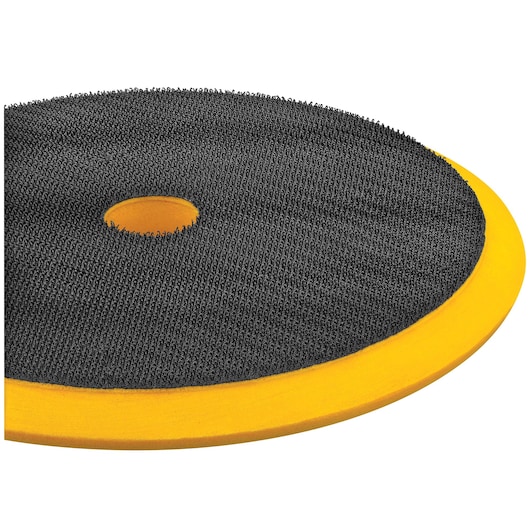 Close-up view of a DEWALT polishing pad with a black textured surface and a yellow foam edge, featuring a central hole.