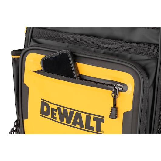 Close-up of a yellow and black DEWALT bag with a front zippered pocket containing a smartphone.