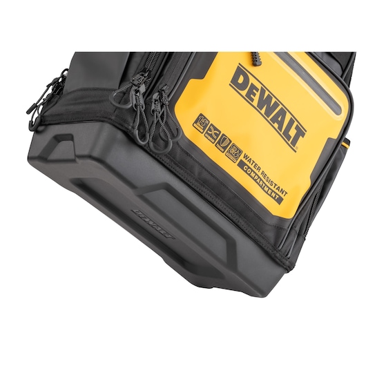 Close-up image of a DEWALT branded bag featuring a yellow water-resistant compartment, multiple zippers, and a sturdy black base.