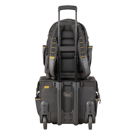 DEWALT rolling tool case with backpack attached, shown from the rear with extended handle and wheels.