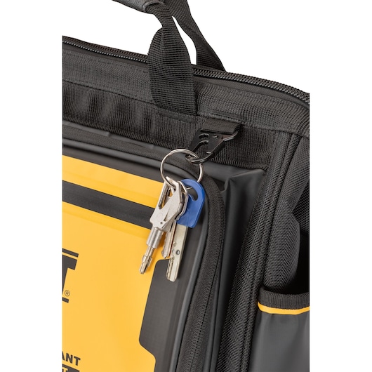 Close-up of a DEWALT bag showing a keyring with several keys attached to a black strap and clip, with yellow and black design details visible.