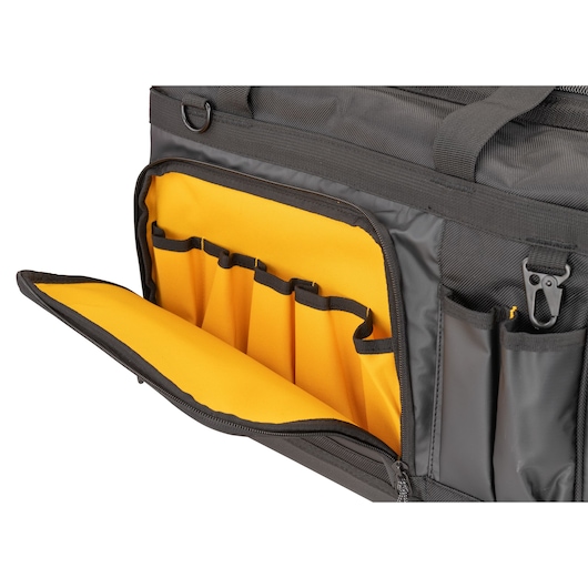 Close-up of a DEWALT photography bag showing an open front compartment with multiple yellow interior pockets designed for organizing accessories and tools.
