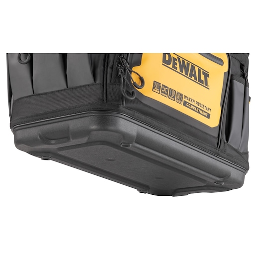 Close-up view of the durable plastic base of a DEWALT tool bag, showing water-resistant compartment labeling and part of the yellow and black design.