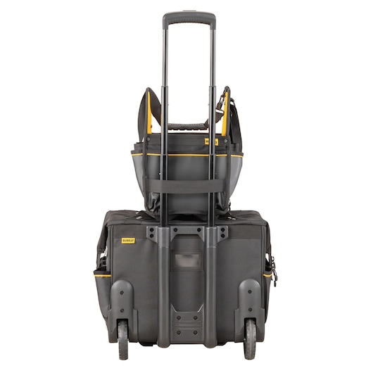 DEWALT rolling tool bag with telescopic handle and a tote stacked on top, black and yellow accents, rear view.