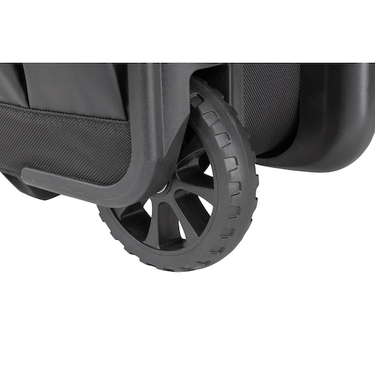 Close-up view of a durable black plastic wheel attached to a DEWALT tool storage box.