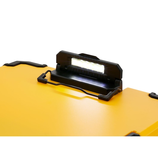 Close-up of a yellow DEWALT toolbox lid with an integrated LED light turned on.