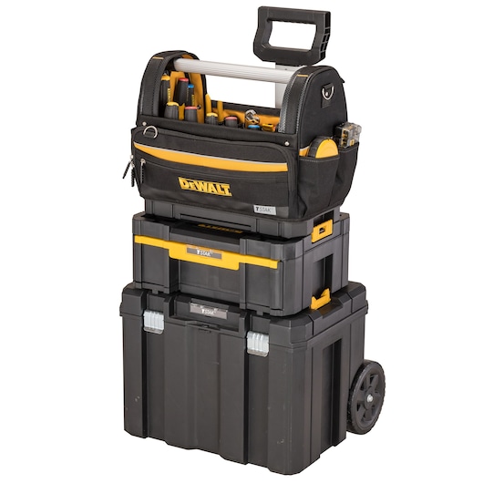 DEWALT modular tool storage system with wheeled base, stackable boxes, and open tool bag on top.