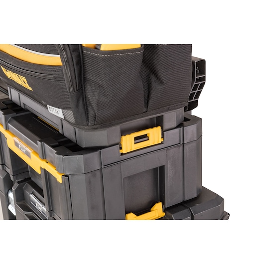 Stacked DEWALT toolboxes and bag with yellow latches, shown close-up for storage organization.