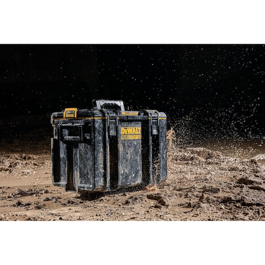 DEWALT ToughSystem 2.0 toolbox in muddy environment, showing durability and water resistance.