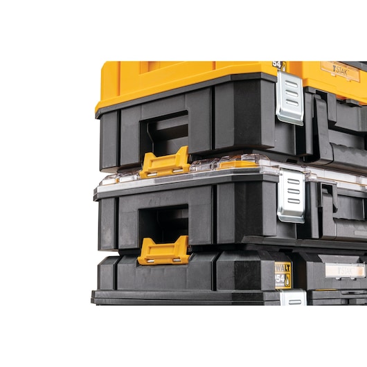 Stacked DEWALT black and yellow toolboxes with metal latches, shown close up from the side.