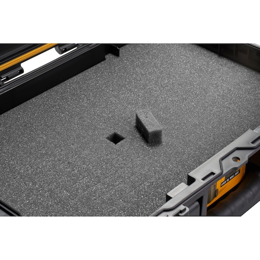 Close-up of a DEWALT case interior with a foam insert featuring removable sections for customizable storage.