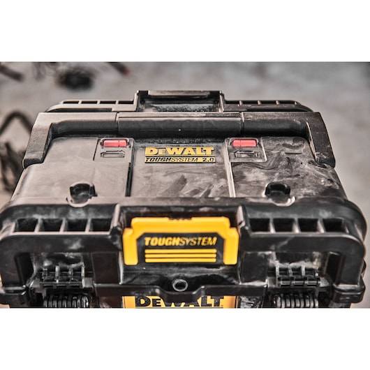 Close-up of a DEWALT Toughsystem 2.0 toolbox showing dust and details on the lid.