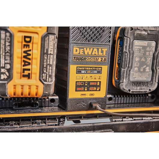 Close-up of DEWALT ToughSystem 2.0 battery charger DWST83471 with detailed labels and USB charging cable.