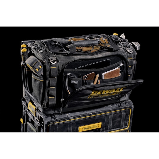 DEWALT ToughSystem 2.0 photography tool bag with compartments, placed on a stackable storage box.