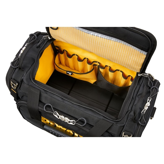 Open DEWALT tool bag with yellow interior, showing organized compartments and pockets for tools.