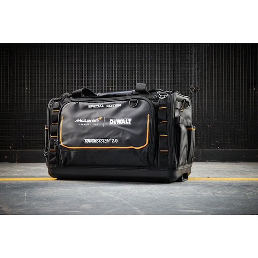 Black DEWALT ToughSystem 2.0 tool bag, special edition, with McLaren branding, on a concrete floor.