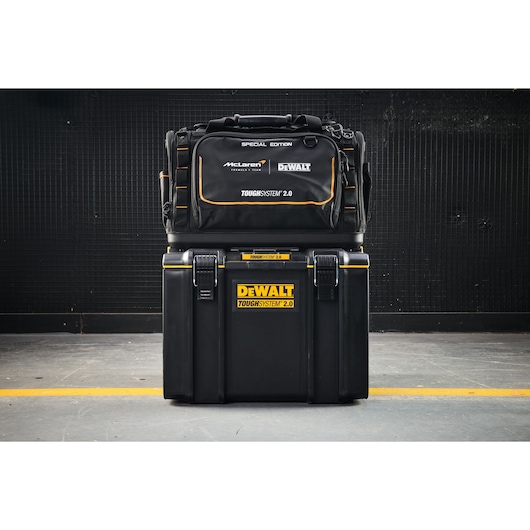 DEWALT ToughSystem 2.0 special edition tool bag and case set stacked on a workshop floor.