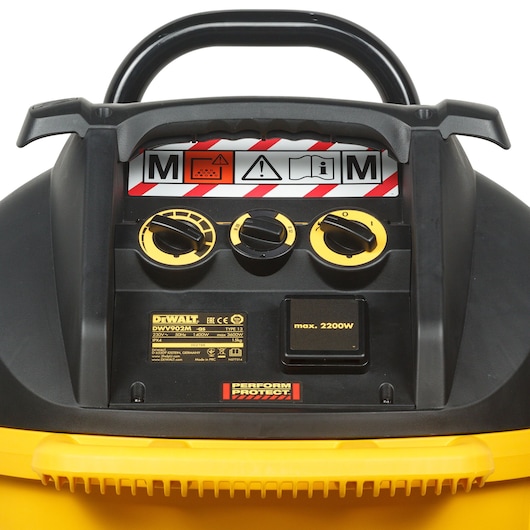 DEWALT DWV902M vacuum control panel with three yellow dials, warning labels, and product info on a black surface.