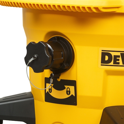 Close-up of a DEWALT yellow machine showing a black rotary knob with lock symbol indicator.