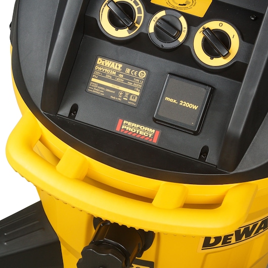 Close-up of DEWALT DWV902M-QS vacuum control panel with labels and dials on yellow housing.